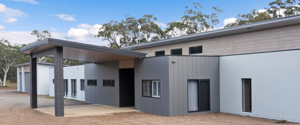 Contemporary custom-built home by Jamie Shaw Building in Bamarang featuring mixed cladding, skillion rooflines and a covered entrance
